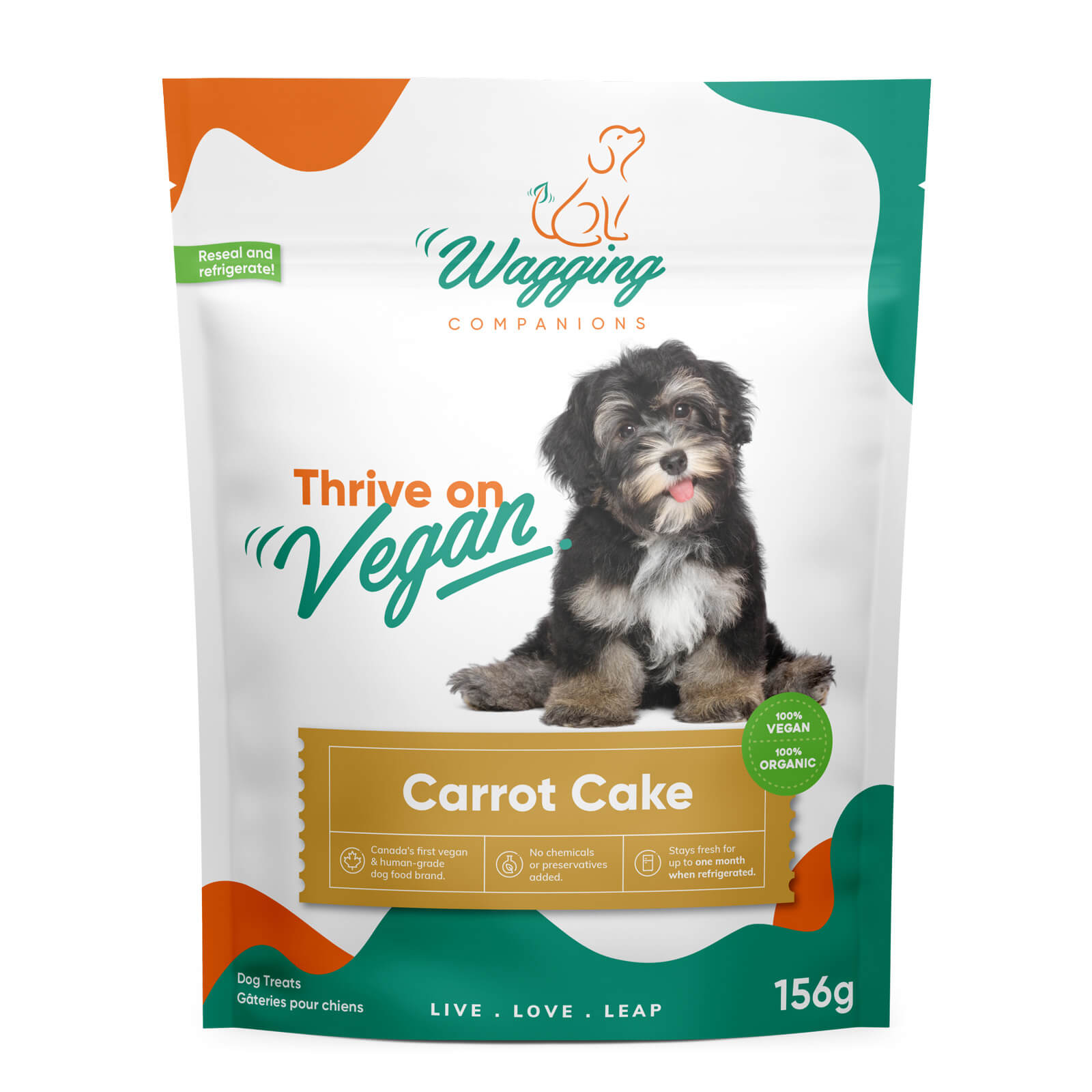 Front view of carrot cake dog treat package, proudly displaying its plant-based, 100% vegan label. Package reveals prominent claim as "Canada's first vegan and human-grade dog food brand".