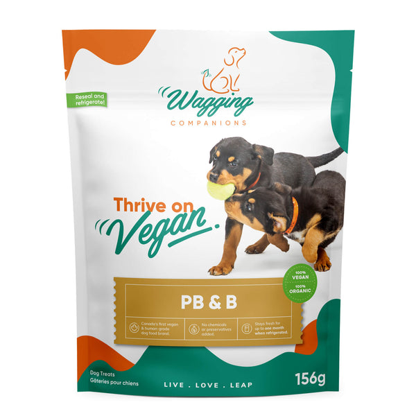 Front view of Wagging Companions' 'PB & B' (peanut butter and banana) blend dog treat packaging, resembling the previous product images. The package highlights the delightful 'PB & B' variety, aligning with the brand's 'Thrive on Vegan' ethos, providing a flavorful, plant-based option infused with peanut butter and banana for pet owners seeking diverse and nourishing treats.